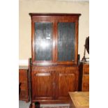 A Victorian mahogany bookcase with moulded cornice, fitted adjustable shelves enclosed two glazed