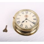 A brass cased bulkhead clock, cream painted dial with seconds dial, 10" dia