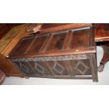 An 18th Century oak coffer with four panel front carved lozenges and plain panelled lid, 55" long