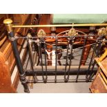 An early 20th Century black iron and brass 4ft metal bedstead