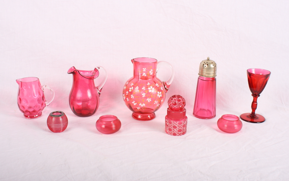 A Victorian ruby glass jug enamelled flowers and a number of other pieces of ruby glass