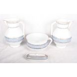 A pair of transfer decorated blue and pink banded toilet jugs, a matching toothbrush holder and a