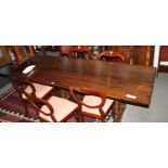 An oak refectory style dining table, on three shaped slap supports, 96" x 32"