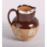 A Doulton Lambeth two-tone brown stoneware hunting jug with applied silver rim, 7" high