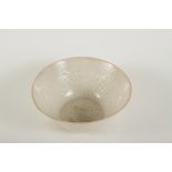 A Chinese Song Dynasty pale green celadon glazed bowl decorated in relief to the inside with