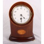 An Edwardian mantel clock in arch top mahogany case inlaid patera, on four brass bun feet, 10" high