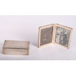 An Edwardian hinged silver double photograph frame and a silver presentation cigarette box