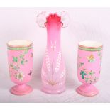 A pair of Victorian pink pedestal glass vases decorated flowers and butterflies, 9" high, and