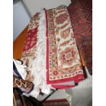 A Qum design carpet decorated central ivory medallion on a red ground, 106" x 76" approx