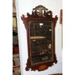 A George III design mahogany framed wall mirror in fretted frame (damages)