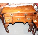 A walnut low boy, fitted one long and three deep drawers, on cabriole supports, 29" wide