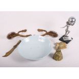 An Art Deco table lighter with nude dancing lady supporter, a pair of spurs, a trench art paper