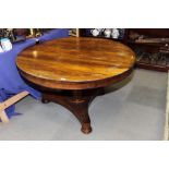 A 19th Century circular rosewood tilt top dining table, on triangular platform base, 48" dia (this