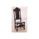 A Charles II design carved oak single chair with narrow carved panel to back, wooden seat, on carved