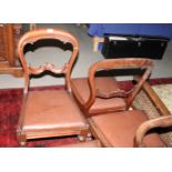 A set of six 19th Century rosewood balloon back dining chairs with scroll carved back rails, drop-in