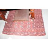 A Bokhara rug decorated three rows of guls on a red ground and multi-bordered, 72" x 50" approx