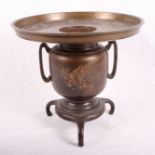 A Japanese bronze vase decorated a pheasant with flared rim and tripod base, 10" high