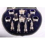 An early 20th Century ten-piece silver double condiment set and seven spoons, in case