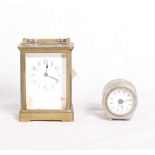 A brass framed carriage clock with white enamelled dial (damaged) and a bedroom clock in plated