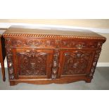 A 19th Century oak sideboard with gadroon carved edge, fitted two drawers and cupboards carved