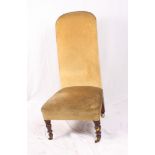 A Victorian nursing chair, upholstered in a gold velour, on turned supports