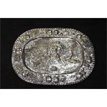 A 19th Century continental silver platter with central embossed Bacchanalian scene, embossed fruit