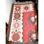 A Caucasian design kilim rug decorated five medallions on a red ground with ivory border decorated