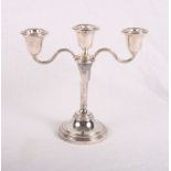 A silver three-branch candelabrum with weighted base