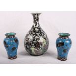 A pair of cloisonne vases decorated roundels on a blue ground (one dented) and an oriental