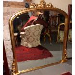 An arch top overmantel mirror with bevelled plate, 49" x 42", in gilt frame with foliate and grape