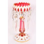 A ruby and white cameo glass table lustre hung glass drops, 10" high