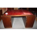 A partner's early 20th Century mahogany double pedestal desk, fitted drawers and cupboards, with