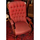 A Victorian mahogany showframe open armchair, button upholstered in a red fabric, on castored