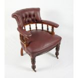 A gentleman's 19th Century walnut showframe library armchair with spindle gallery back,