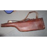 A brown leather "leg o' mutton" gun case