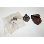 A WWI brass prismatic compass by Cruchon & Emons in leather belt pouch, a leaded glass panel