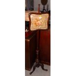 A 19th Century mahogany pole screen with square shaped floral needlework panel on carved tripod