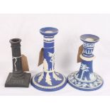 A 19th Century Wedgwood black basalt reeded column candlestick and two later Wedgwood blue
