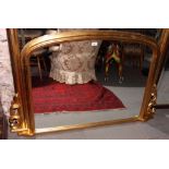 A gilt framed arch top overmantel mirror, plate 28 1/2" x 38"