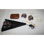 A burr wood rectangular snuff box, two napkin rings made from shells, a black fan and four carved