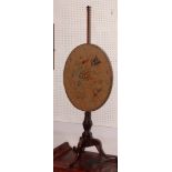 A 19th Century mahogany pole screen with oval floral tapestry panel on tripod base