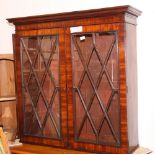 A Georgian mahogany bookcase enclosed astragal glazed doors and moulded cornice, two adjustable