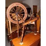 A 19th Century spinning wheel and a pair of carding paddles