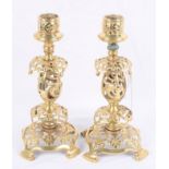 A pair of ornate Victorian brass candlesticks with pierced decoration
