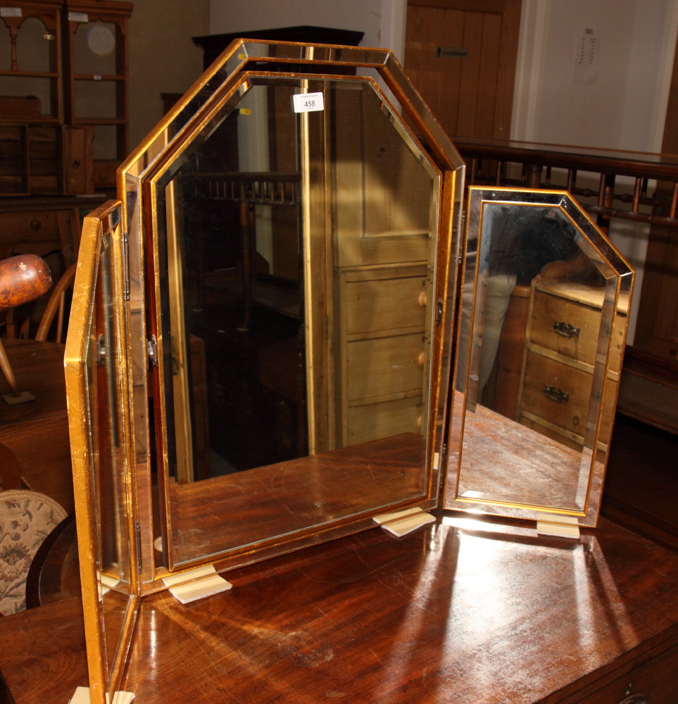 A triple dressing table mirror in gilt decorated frame inset mirror panels