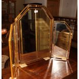 A triple dressing table mirror in gilt decorated frame inset mirror panels