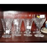A set of six water glasses with inverted bell bowls cut swags and two large wine glasses with fan
