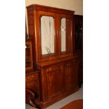 A 19th Century mahogany bookcase, the upper section enclosed glazed doors over cupboard base