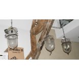 A pair of pendant ceiling lights with diamond cut glass shades, 18" high, and a similar plain