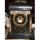 A 19th Century slate and marble mantel clock with eight-day striking movement, 18" high